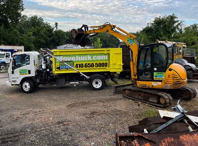 Move Junk truck utilizing an excavator