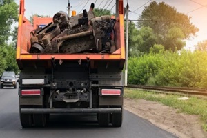 rear view of a dump truck loaded on the road laden with scrap metal