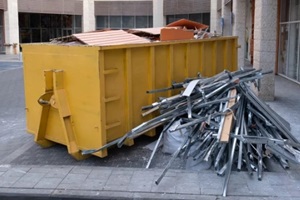 huge heap on metal Big Overloaded dumpster waste container filled with construction waste