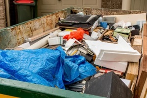 skip bin full of household waste rubbish on the frond yard